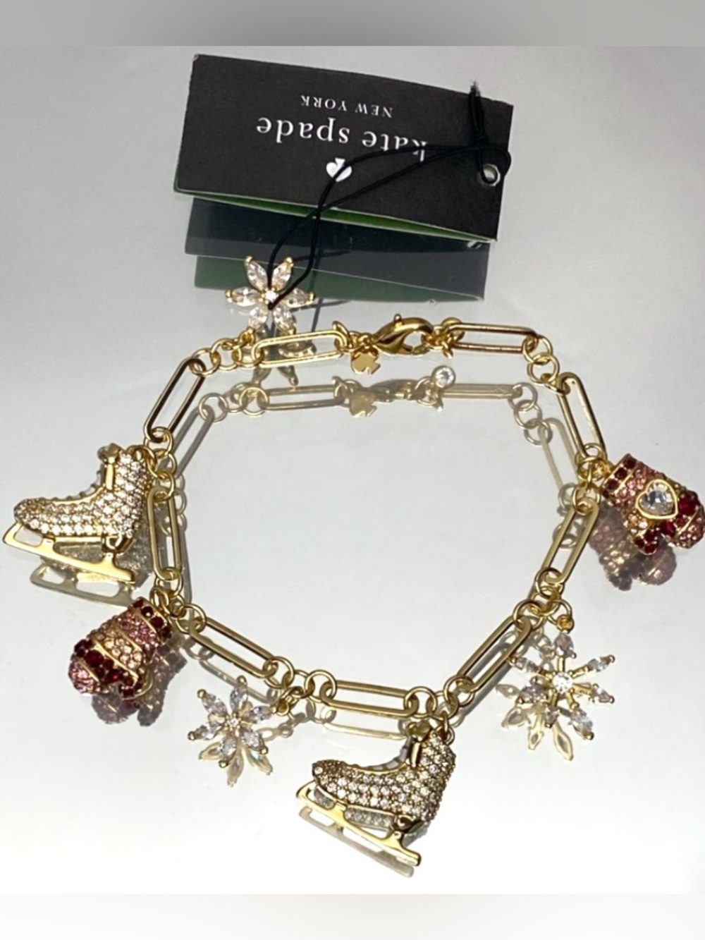 kate spade Gold-Tone Ice Skate & Snowflake Charm Bracelet with Pink Accents - Picture 1 of 9